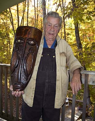 Joseph Johns holding one of his woodcarvings, a corn mask., Native American woodcarving, ; Joseph Johns (b. 1930); New Salem, Massachusetts; Collection of the artist; Photography by Maggie Holtzberg