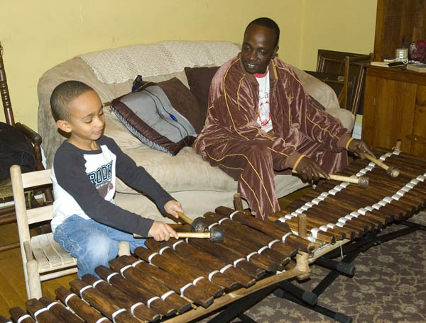 Balla Kouyaté (right) and his son Sekou playing balafons, Malian Djeli balafon music, 2012; Medford, Massachusetts; Photography by Maggie Holtzberg
