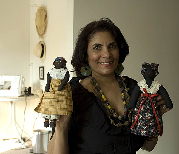 Posing with two of her black dolls, Dollmaking, 2009; Ivelisse Pabon de Landron (b. 1952); Ashland, Massachusetts; Photography by Maggie Holtzberg