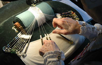 Linda Lane making bobbin lace, Bobbin lacemaker, 2015; Linda Lane; Salem, Massachusetts; Linen thread, bobbins, velvet; Photography by Maggie Holtzberg