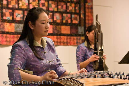 Shin Yi Yang (foreground) playing the guzheng, Chinese guzheng and gu-qin playing, 2003; Brighton, Massachusetts;