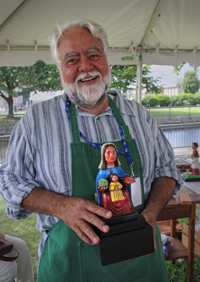 Carlos Santiago Arroyo demonstrating in the folk craft area of the Lowell Folk Festival; Puerto Rican woodcarving; 2013: Lowell, Massachusetts