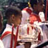 Children carrying crown and candles entering church; Ethnic festival; 2001: New Bedford, Massachusetts
