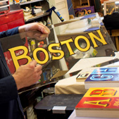 Josh Luke holding a Boston style sign painting; Sign painting; 2015: Dorchester, Massachusetts; Reverse glass gilding; 12 x 24 inches