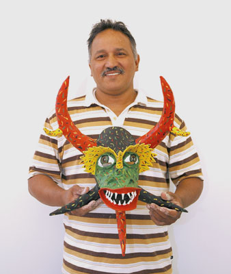 Angel Sánchez Ortiz holding mask; Puerto Rican carnival mask; 2006: 