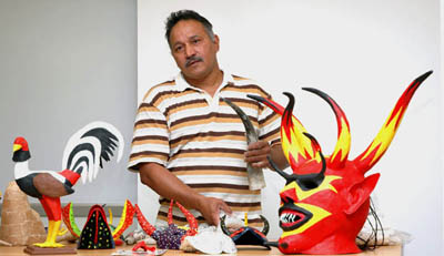 Angel Sánchez Ortiz with some of his masks; Apprenticeship - Puerto Rican carnival mask making; 2006: Springfield, Massachusetts; Painted papier mâché